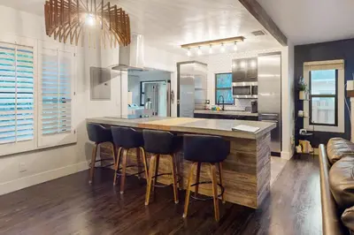 a kitchen with a island with bar stools at Walking On Sunshine in Fort Lauderdale
