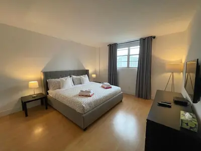 a bedroom with a bed and a television in it at Stunning apt! Oceanview! Parking included in Sunny Isles Beach