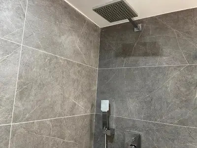 a bathroom with a large tile shower with a vent at Amazing Ocean View! 10 floor Parking included in Sunny Isles Beach