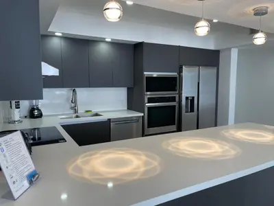 a kitchen with black cabinets and a white counter top at Amazing Ocean View! 10 floor Parking included in Sunny Isles Beach