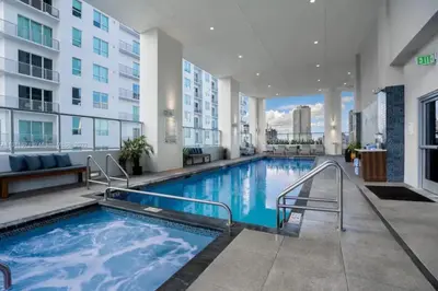 a large swimming pool in a building with a building at Ocean View Designer Studio, Pool in Miami
