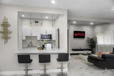 a kitchen and living room with a couch and a counter at Miami Luxury Home Rental in Miami