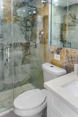 a bathroom with a toilet and a glass shower at Miami Luxury Home Rental in Miami