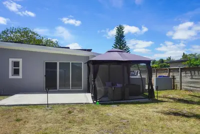 a purple umbrella sitting in a yard next to a house at Miami Luxury Home Rental in Miami
