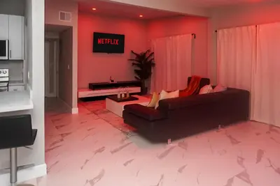 a woman sitting on a couch in a living room at Miami Luxury Home Rental in Miami