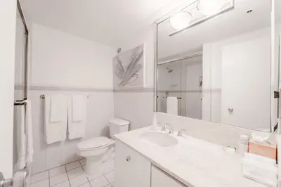 a white bathroom with a toilet and a sink at AK414- Miami Beach Apt at Oceanfront Resort in Miami Beach