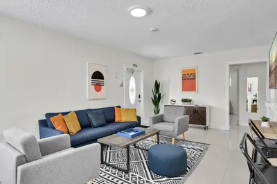 a living room with a blue couch and a table at Hollywood Villa Luxury & Private Pool in Hollywood