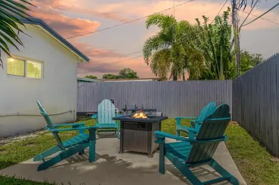 a patio with two chairs and a table with a fire pit at Hollywood Villa Luxury & Private Pool in Hollywood