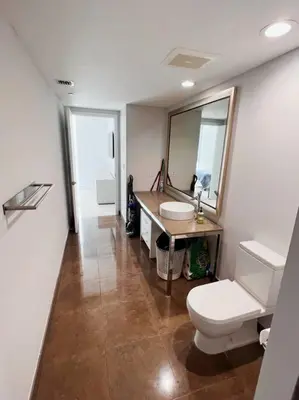 a bathroom with a toilet and a sink and a mirror at Luxury condo in Icon W hotel Brickell in Miami