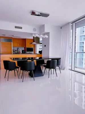 a dining room with a table and black chairs at Luxury condo in Icon W hotel Brickell in Miami