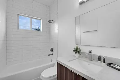 a bathroom with a sink and a toilet and a window at Biscayne Park Villas 15400 in Miami