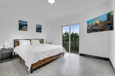 a bedroom with a bed and a large window at Biscayne Park Villas 15400 in Miami