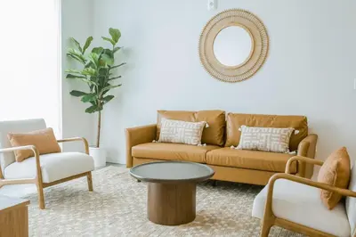 a living room with a couch and a table at Hard Rock Stadium Home Base! Luxe Condo with Pool in Joe Robbie Stadium Heliport