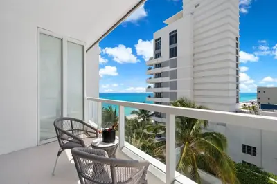 a balcony with chairs and a view of the ocean at FontaineBleau Resort, with Balcony 10 min from SoBe in Miami Beach