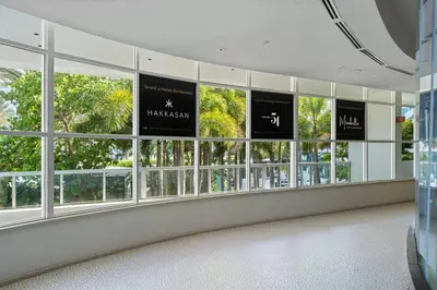 a row of windows in a building with palm trees at FontaineBleau Resort, with Balcony 10 min from SoBe in Miami Beach