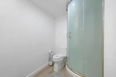 a bathroom with a toilet and a glass shower at Beautiful holiday apartment in Ocean Recerve near beach in Sunny Isles Beach