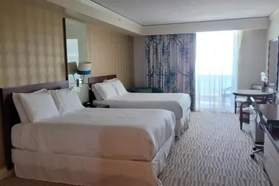 a hotel room with two beds and a window at Luxurious beachfront studio in Sunny Isles Beach