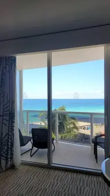 a living room with a view of the ocean at Luxurious beachfront studio in Sunny Isles Beach