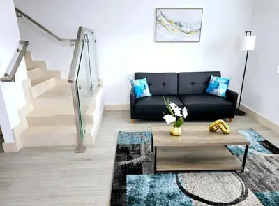 a living room with a black couch and a coffee table at Biscayne Park Villas 15450 in Miami