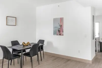 a dining room with a black table and chairs at Biscayne Park Villas 15450 in Miami