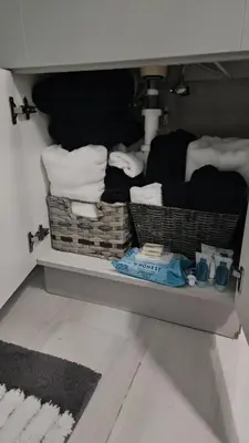 a room with baskets and towels on a shelf at Jade in Miami