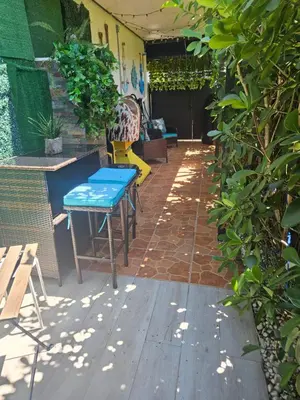 a patio with a blue table and a bench at Jade in Miami