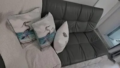 a couch with two pillows on top of it at Jade in Miami