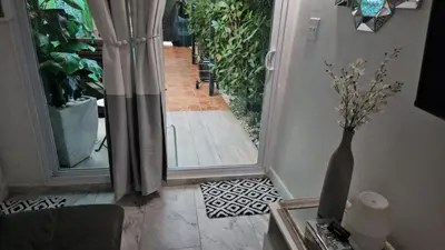 a vase sitting on a table next to a door at Jade in Miami