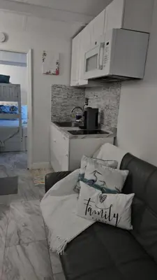a living room with a couch and a kitchen at Jade in Miami