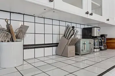 a kitchen with a counter with utensils on it at 5 Minute Walk to Wilton Drive in Fort Lauderdale