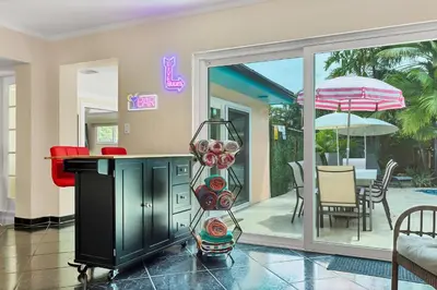 a living room with a table and an umbrella at 5 Minute Walk to Wilton Drive in Fort Lauderdale