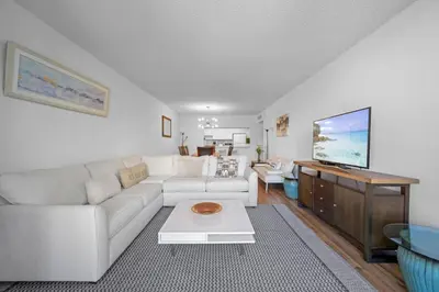 a living room with a white couch and a table at Nice and economic family apartment on the beach in Sunny Isles Beach