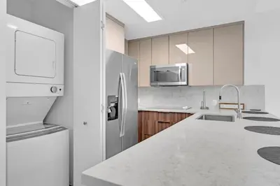 a white kitchen with a refrigerator and a sink at Biscayne Park Villas 15440 in Miami
