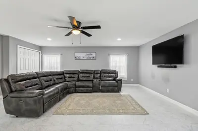 a leather couch in a living room with a ceiling fan at Spacious 3BR Villa in Miami with Fenced Backyard in Miami