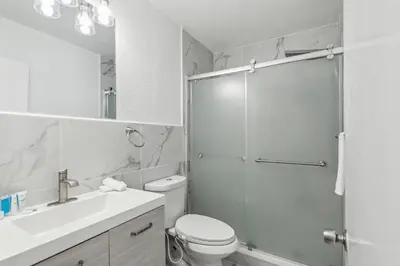 a bathroom with a shower and a toilet and a sink at Spacious 3BR Villa in Miami with Fenced Backyard in Miami