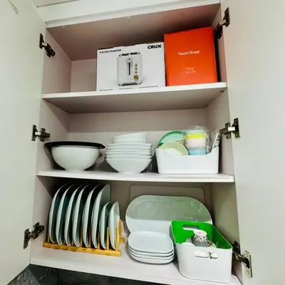 a cabinet filled with dishes and bowls and a box at BRAND NEW! Lovely 1 Bedroom with Pool by the Beach in Miami