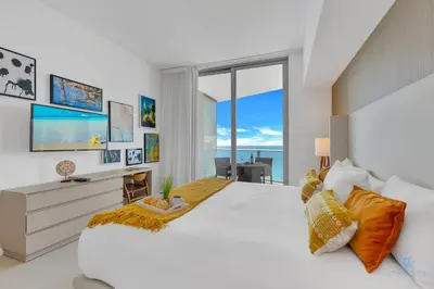 a white bedroom with a large bed and a large window at Hollywood Beachfront Apt Amazing View & Amenities in Hollywood