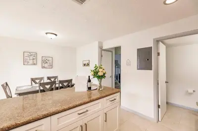 a kitchen with a counter and a dining room at Miami Oasis 7 mins to Dolphin Mall MIA PS4 Games in Miami