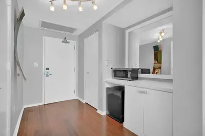 a kitchen with white cabinets and a black microwave at Tropical Paradise Spacious 3 bedroom in Miami
