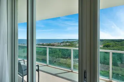a room with a view of the ocean through windows at Tropical Paradise Spacious 3 bedroom in Miami