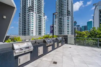 a row of sinks on a balcony with tall buildings at Amazing location in the heart of Miami in Miami