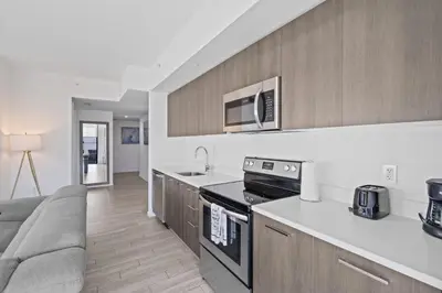 a kitchen with a couch and a stove top oven at Amazing location in the heart of Miami in Miami