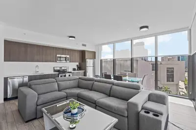 a living room with a couch and a kitchen at Amazing location in the heart of Miami in Miami