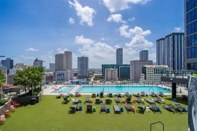 a large pool with lounge chairs and a city skyline at Amazing location in the heart of Miami in Miami