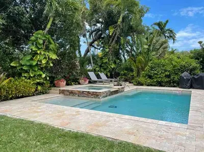 a swimming pool in a yard with a bench next to it at Villa Viscayne - Miami Modern Luxury with Pool & Spa in Biscayne Park