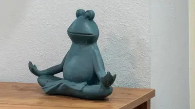 a green frog statue sitting on a wooden table at Villa Tropical - Your private Miami Resort with a heated pool in North Miami