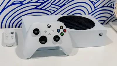 a video game controller next to a game console at Villa Tropical - Your private Miami Resort with a heated pool in North Miami