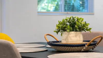 a basket with a plant in it on a table at Villa Tropical - Your private Miami Resort with a heated pool in North Miami