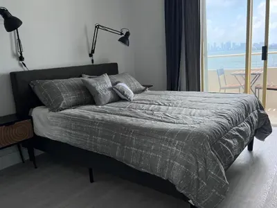 a bedroom with a bed with a view of the ocean at Unique Water Views, free Parking 1bed 1 bath Rooffornomads 416 in Miami Beach