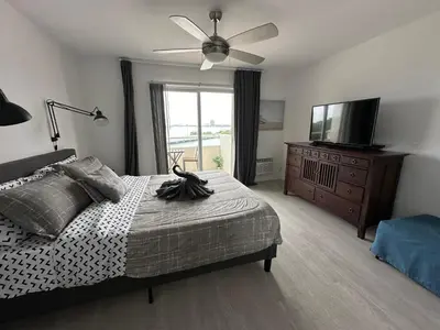 a bedroom with a bed and a flat screen tv at Unique Water Views, free Parking 1bed 1 bath Rooffornomads 416 in Miami Beach